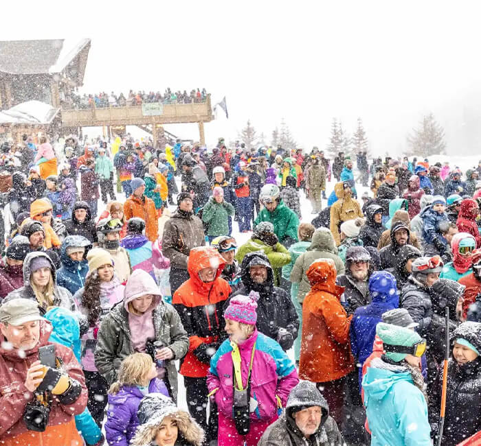 Standing crowd in the snow at dummy downhill event